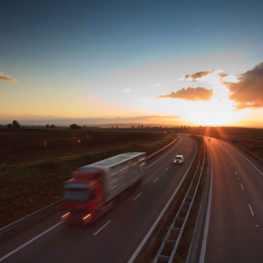 LKW auf dem Arbeitsweg beim Sonnenuntergang